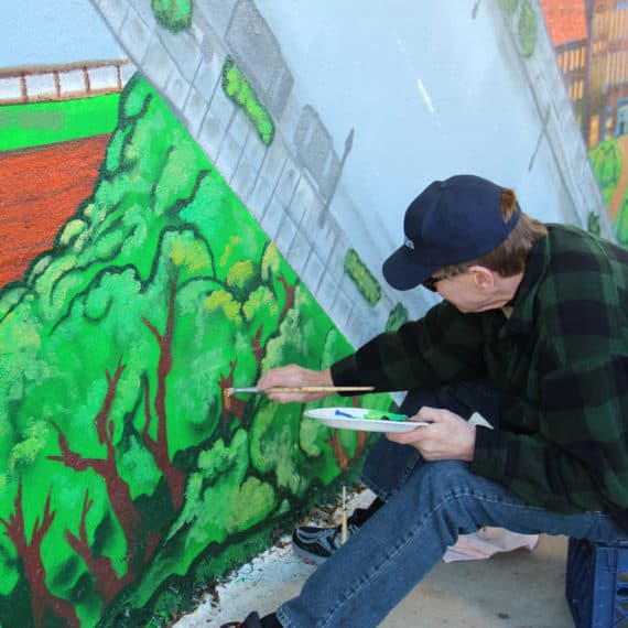 Ken Klopack helping to paint his son's mural