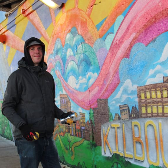 Ken R. Klopack painting his mural