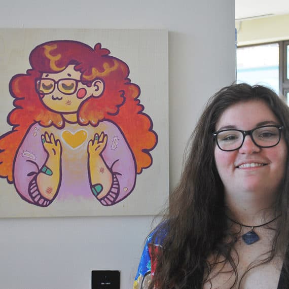 Alumna artist Amanda with her painting in Around the Corner multi-high school art exhibition 2017