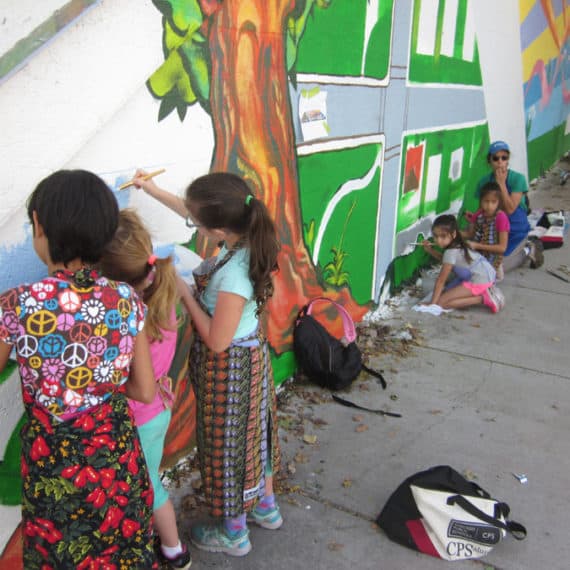 Neighborhood kids helping to paint Ken R. Klopack's mural