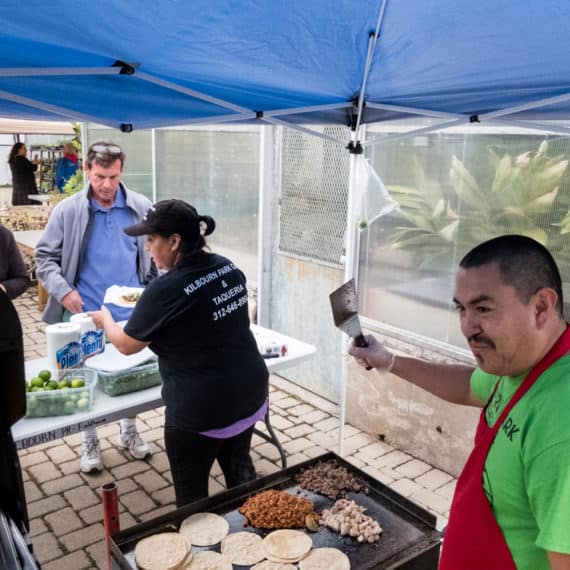 Jaime of Kilbourn Park Cafe making tacos for 30th Ward Year of Public Art (YOPA) community celebration / opening reception